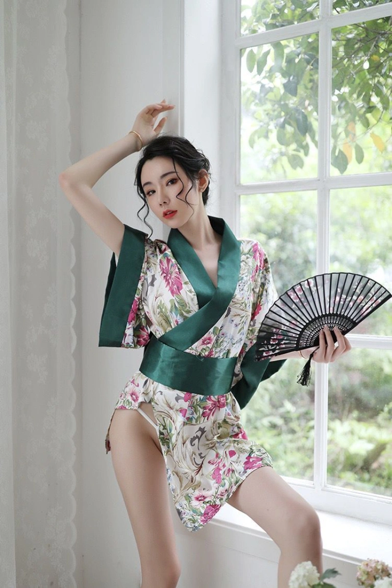 Alt text: Woman posing in alluring sexy geisha lingerie with green sash and floral kimono