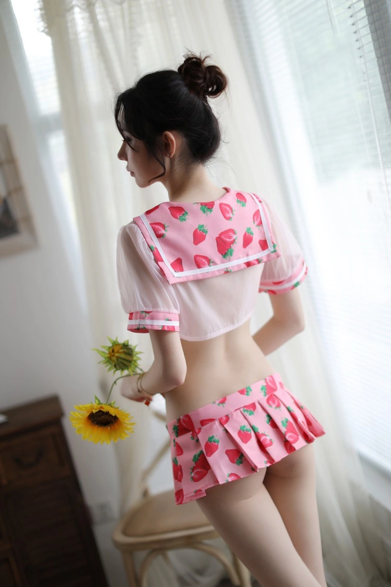 Back view of sheer student lingerie in pink with strawberry print sailor collar and pleated mini skirt.