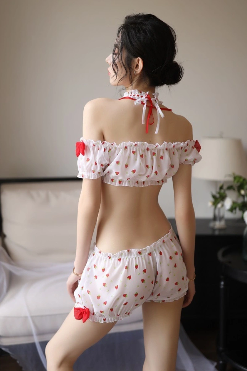 Model showing the back of lace pajama top and shorts with strawberry print and bow details