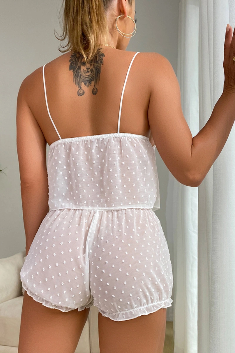 Backside of white lace pajama lingerie set showing adjustable straps and elastic waistband