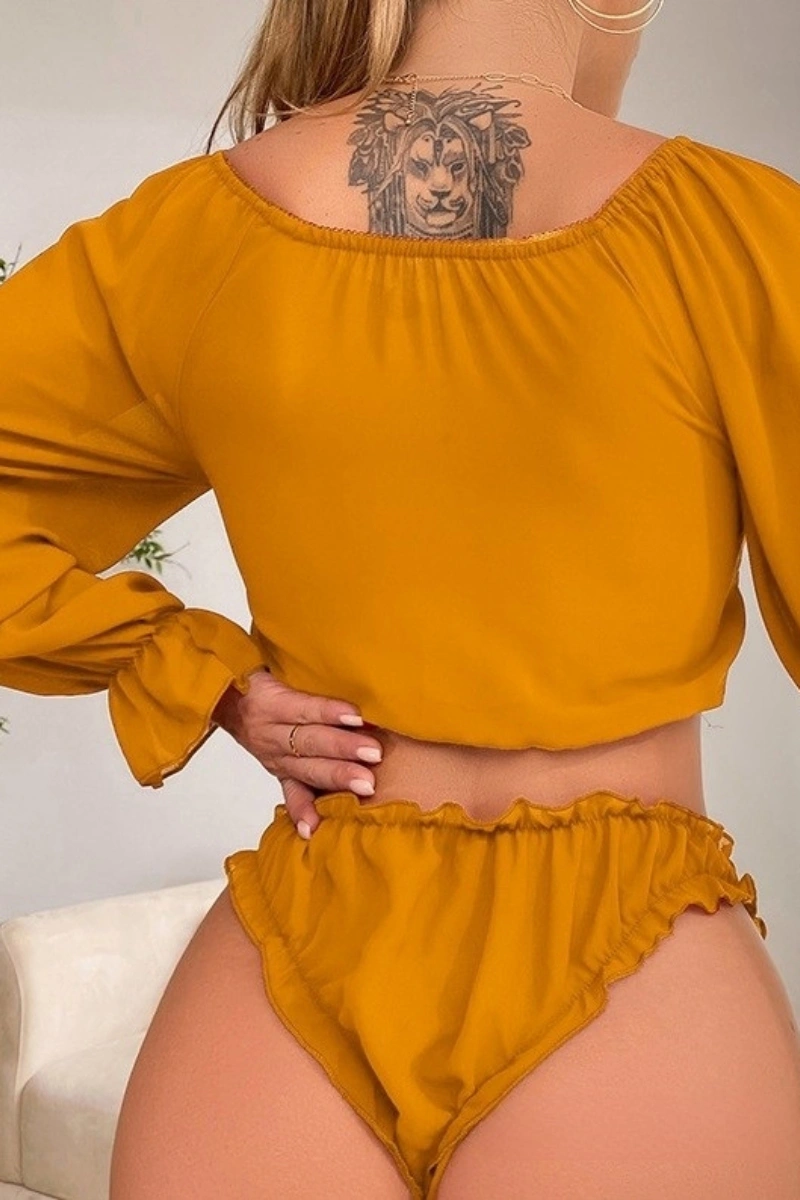 Model showcasing the back of mustard yellow cotton lace pajamas with ruffled panties.
