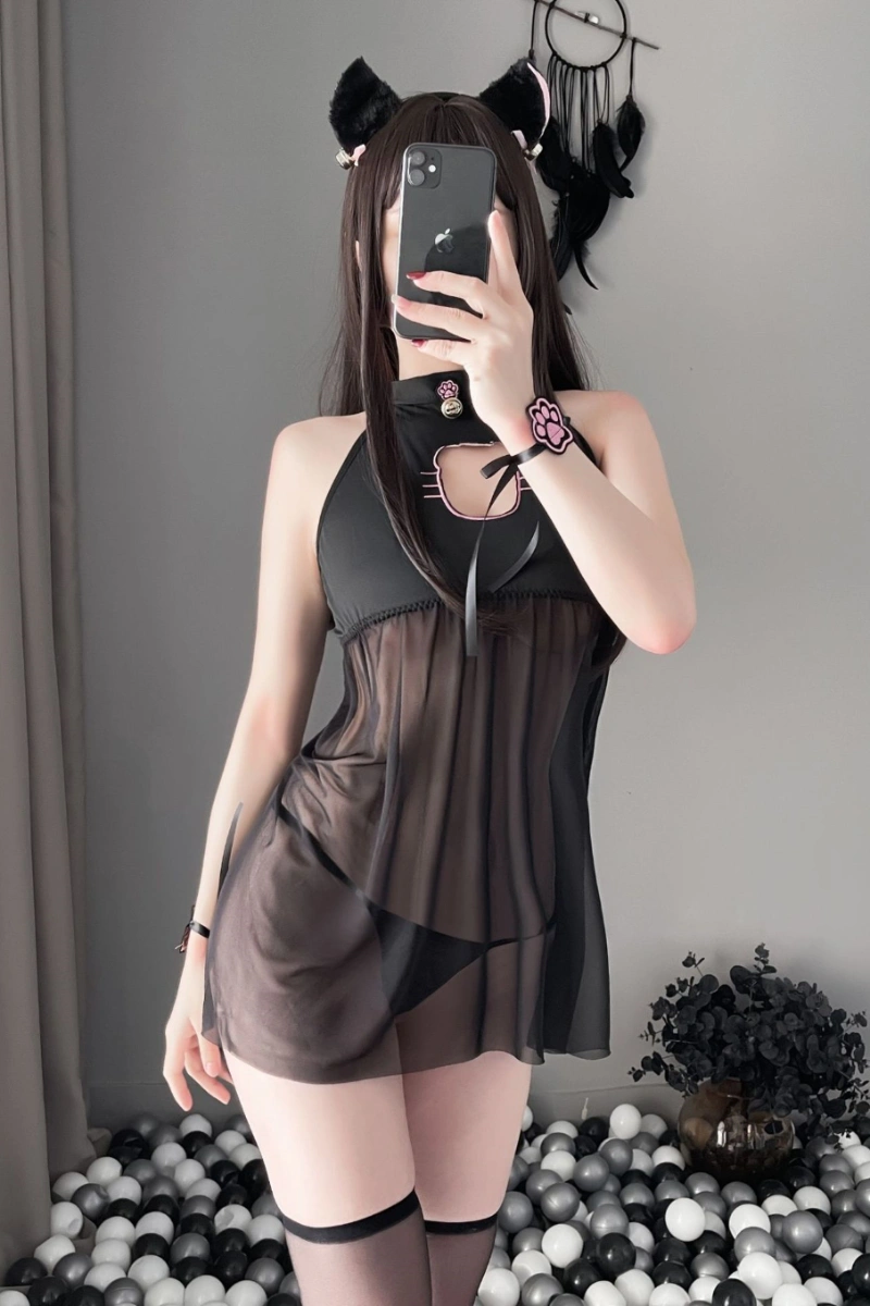 Model in a black sheer cat lingerie dress with cat ears and pink paw details.