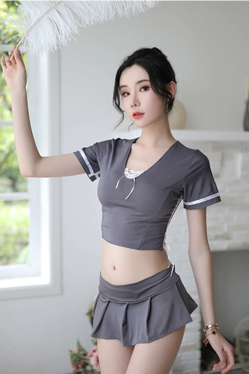 Model wearing JK anime cosplay lingerie in gray, featuring a fitted crop top and pleated mini skirt.