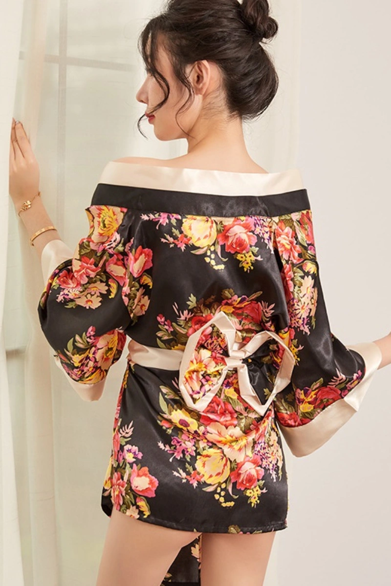 Alt text:Back view of black floral satin kimono sleeve lingerie with ivory trim and bow