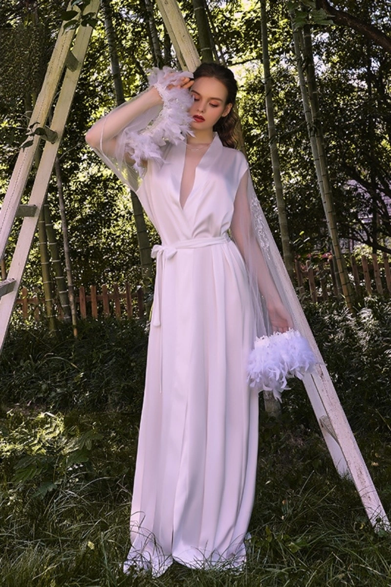 White custom Long Sexy Nightgown with lace sleeves and feather cuffs in a garden setting