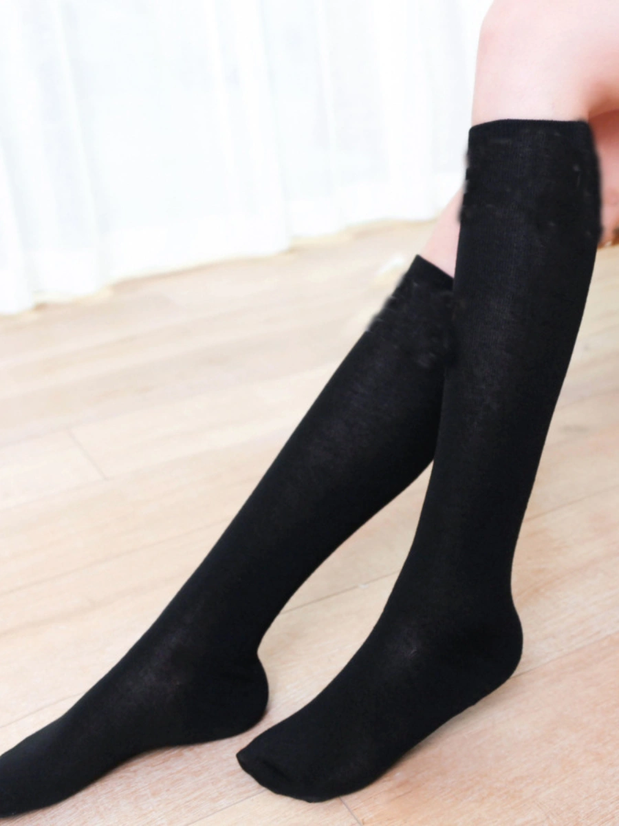 Model wearing plain white knee high silk stockings with simple elastic finish
