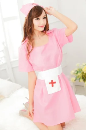 Plus size sexy nurse costume featuring a pink mini dress with short sleeves, white apron, and matching hat.