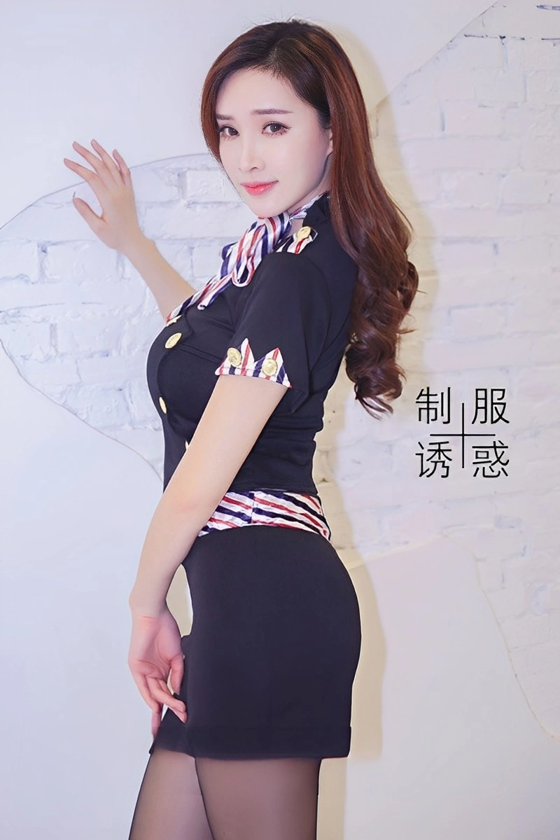 Female model in a black Airline Attendant Bodysuit with striped accents and gold buttons, posing indoors.