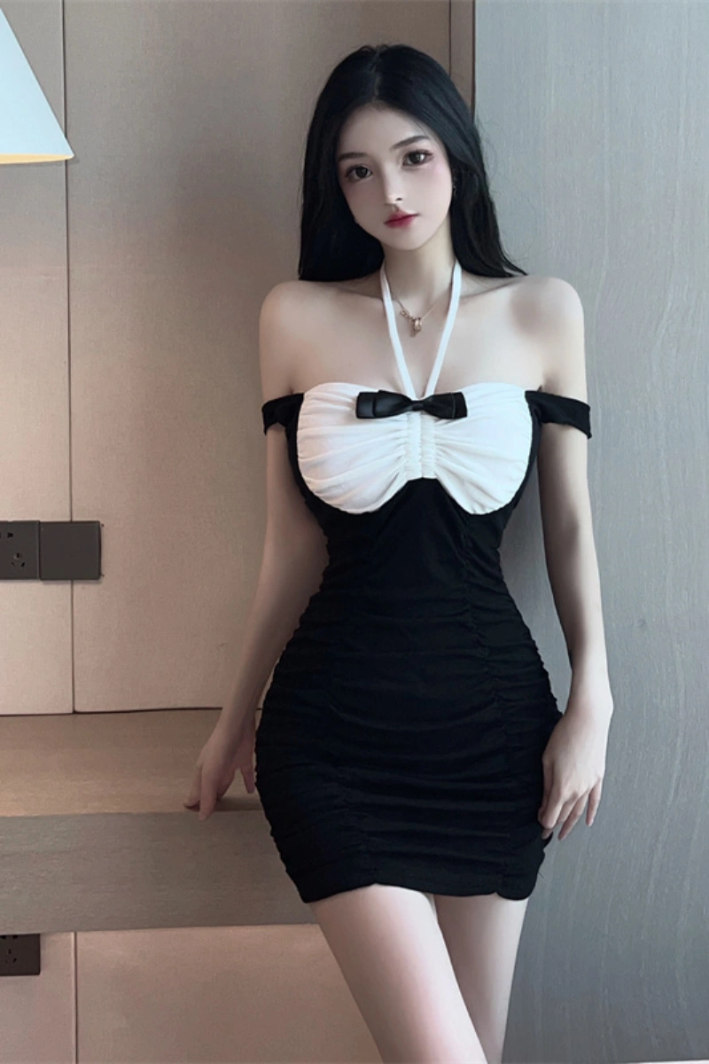 Model in a black seductive secretary dress with off-shoulder neckline and white ruched bust.