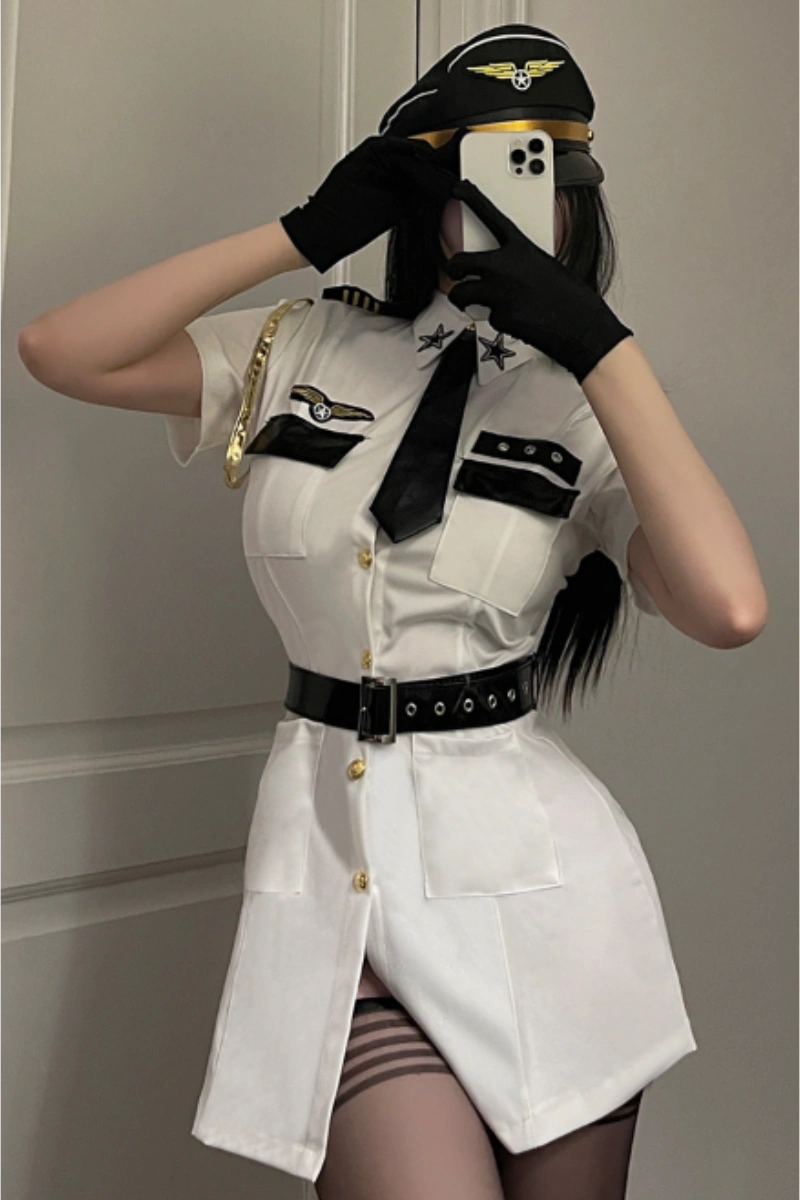 Sexy Flight Uniform Dress in white with aviation patches, black tie, and captain hat.