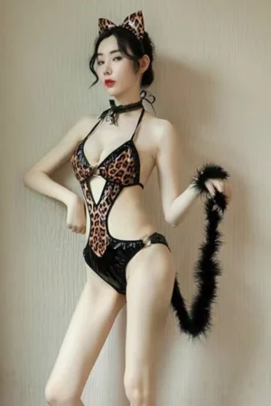 Model wearing leopard print wholesale cat lingerie outfit with matching cat ears and furry tail.