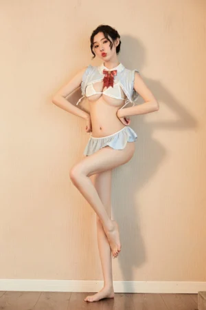 Model posing in a "naughty bunny lingerie" set, highlighting the ruffled blue skirt and the bunny-themed top with a red bow.