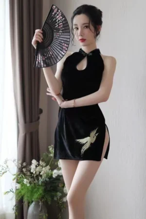 Woman in sexy vintage cheongsam lingerie with golden bird embroidery and side slit.