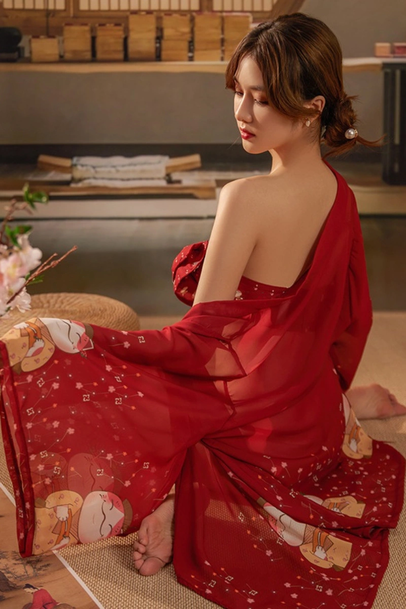 Alt Text:Model seated in sheer printed red kimono loungewear for women