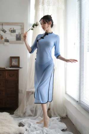 Model in sheer b2b blue cheongsam lingerie with traditional buttons and ankle-length design