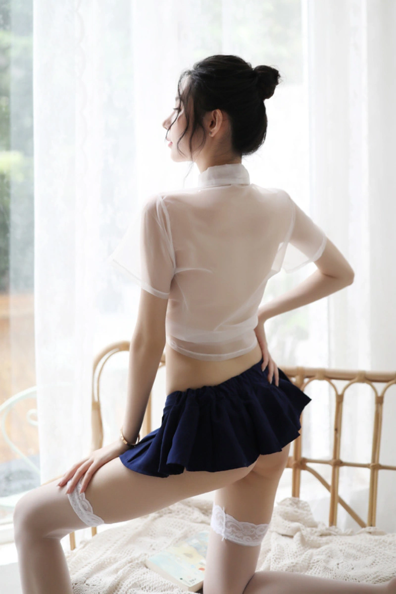 Back view of b2b student fantasy lingerie in sheer white blouse paired with navy pleated skirt