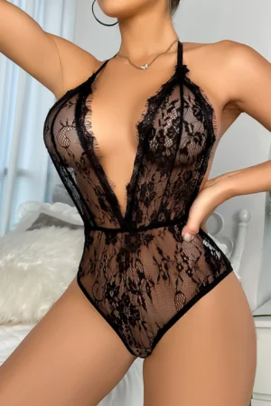 Model in a black lace pajama party outfit featuring a plunging neckline and sheer lace design