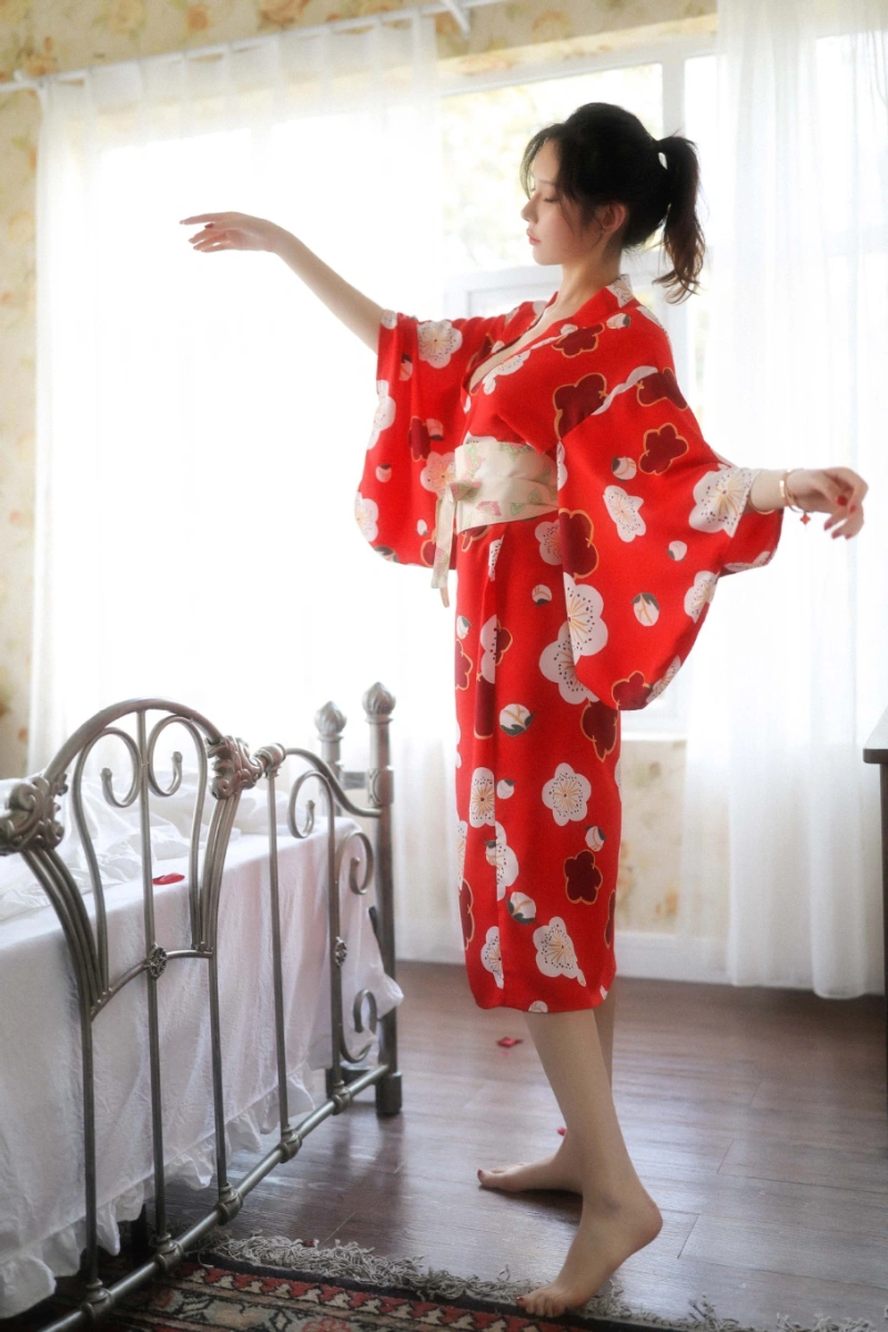 Alt text:Side profile of model in red floral kimono inspired lingerie with sash belt