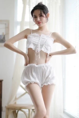Alt Text: Stylish white wholesale Maid Costume two-piece set with crop top and ruffle shorts