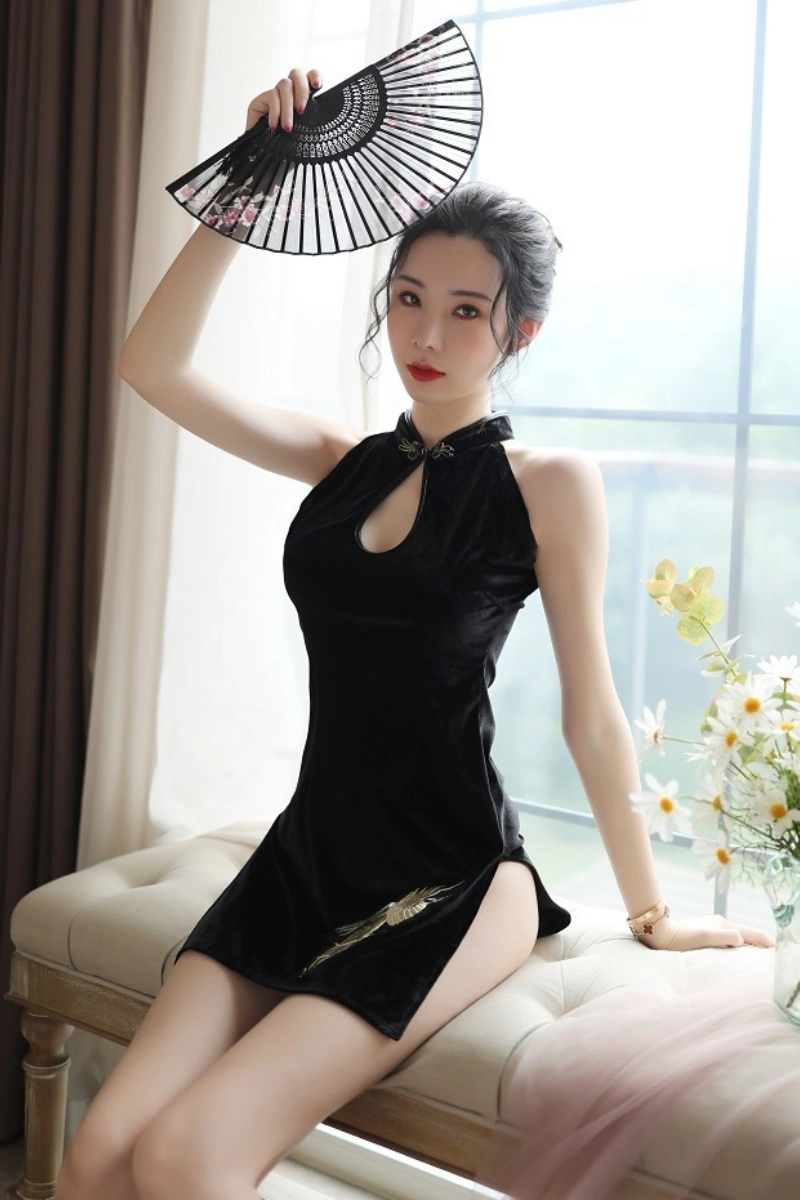 Elegant vintage cheongsam lingerie in black velvet with golden embroidery, styled with a hand fan.