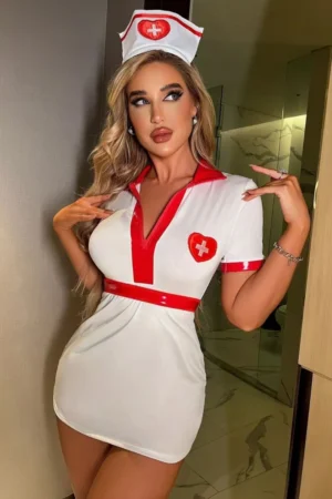 Model posing in white red nurse costume with short sleeves, red collar, and heart cross emblem