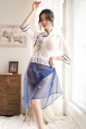 Model wearing a cheongsam lingerie set in white top and sheer blue skirt.