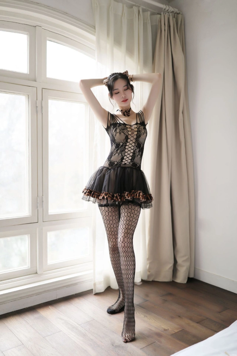 Model wearing wholesale cosplay cat lingerie in black lace with hollow-out design and leopard trim