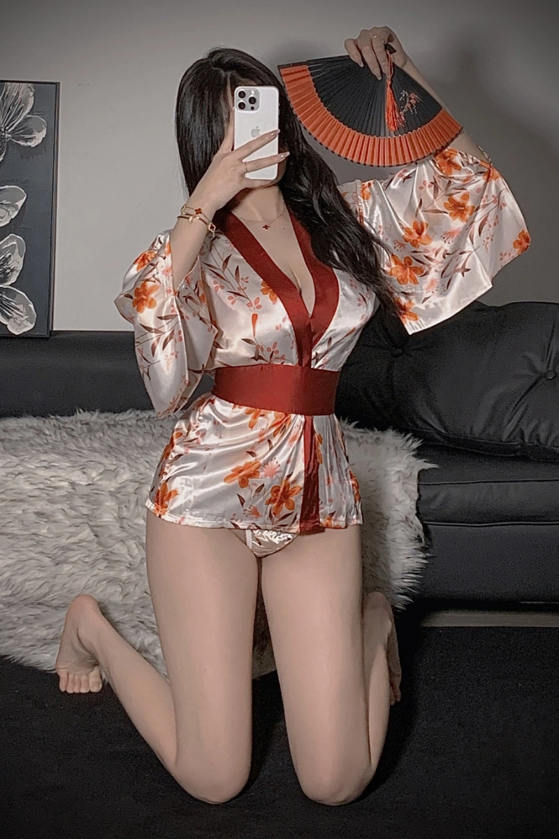 Alt Text:Wholesale kimono robe lingerie in satin fabric with orange floral design, model sitting pose