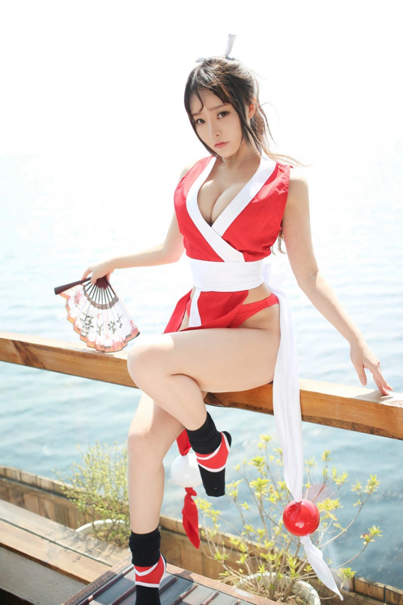 Alt Text:Wholesale lace kimono lingerie in red and white design, seaside photo