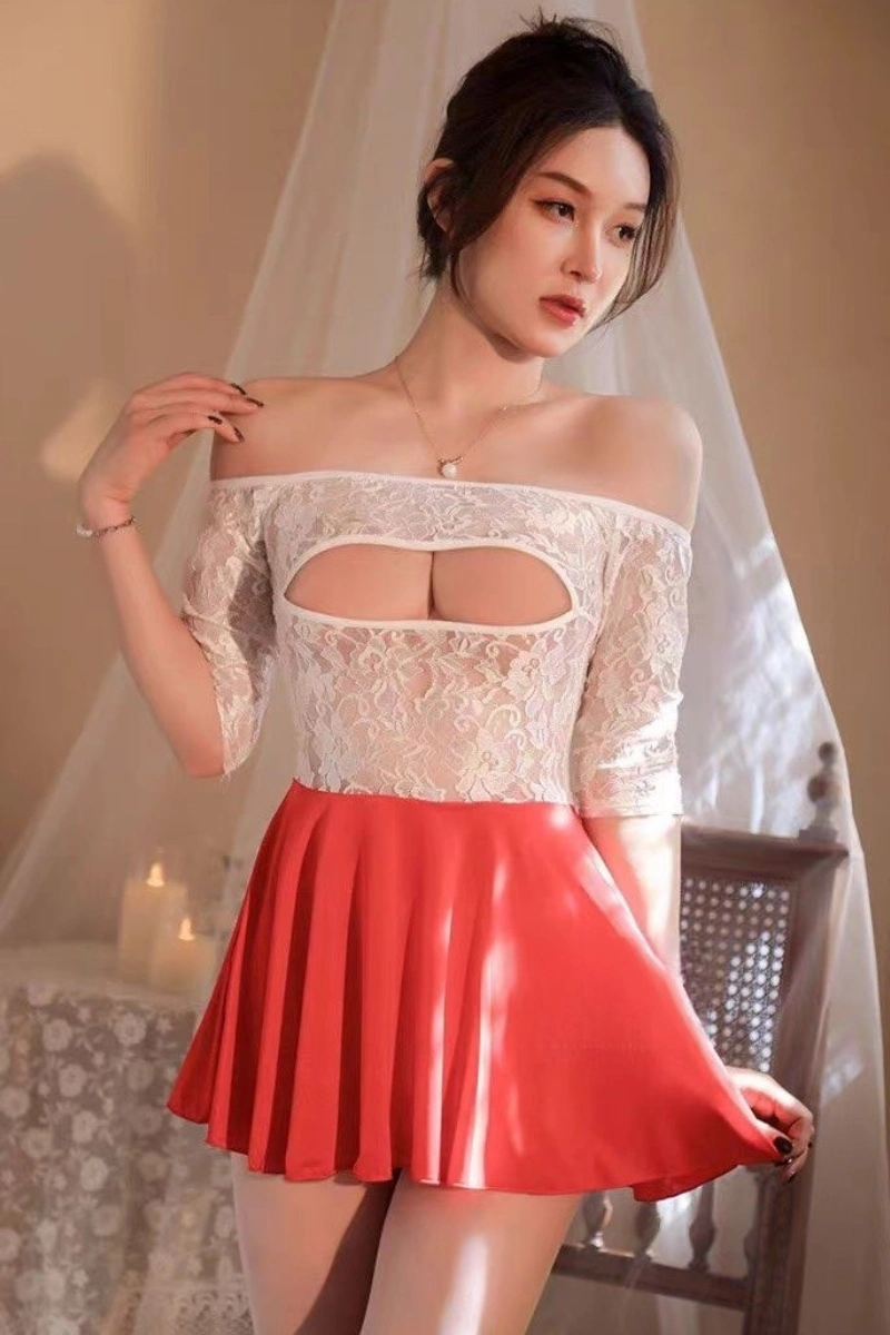 Model dressed in a wholesale secretary fantasy outfit with an off-shoulder white lace top and red mini skirt.