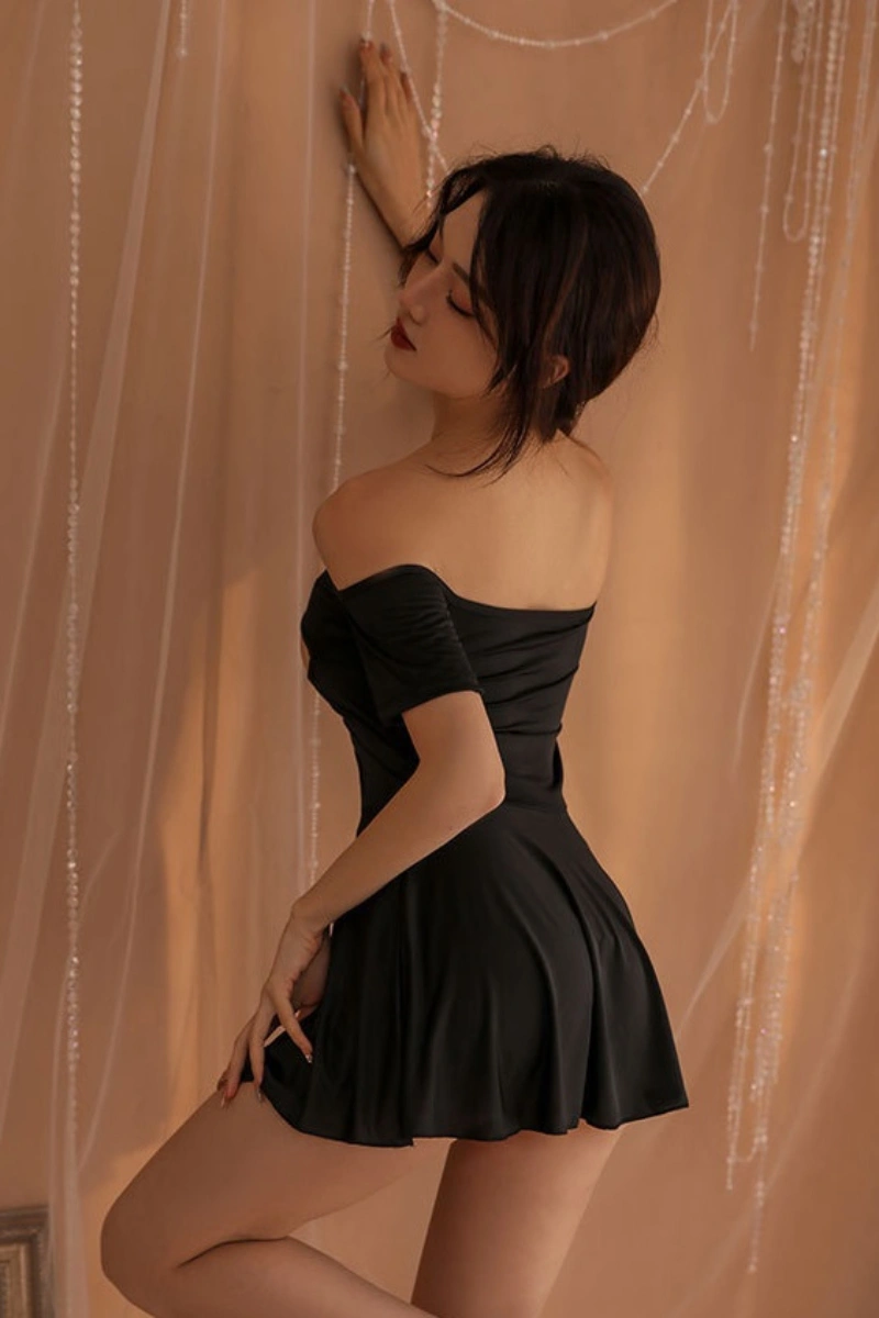 Back view of wholesale sexy office girl costume in black with open shoulder and flared mini skirt.