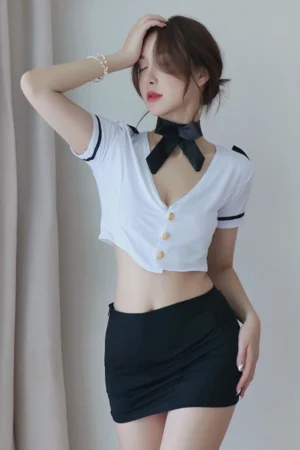 Woman posing in wholesale sexy secretary costume with short white blouse and black mini skirt.