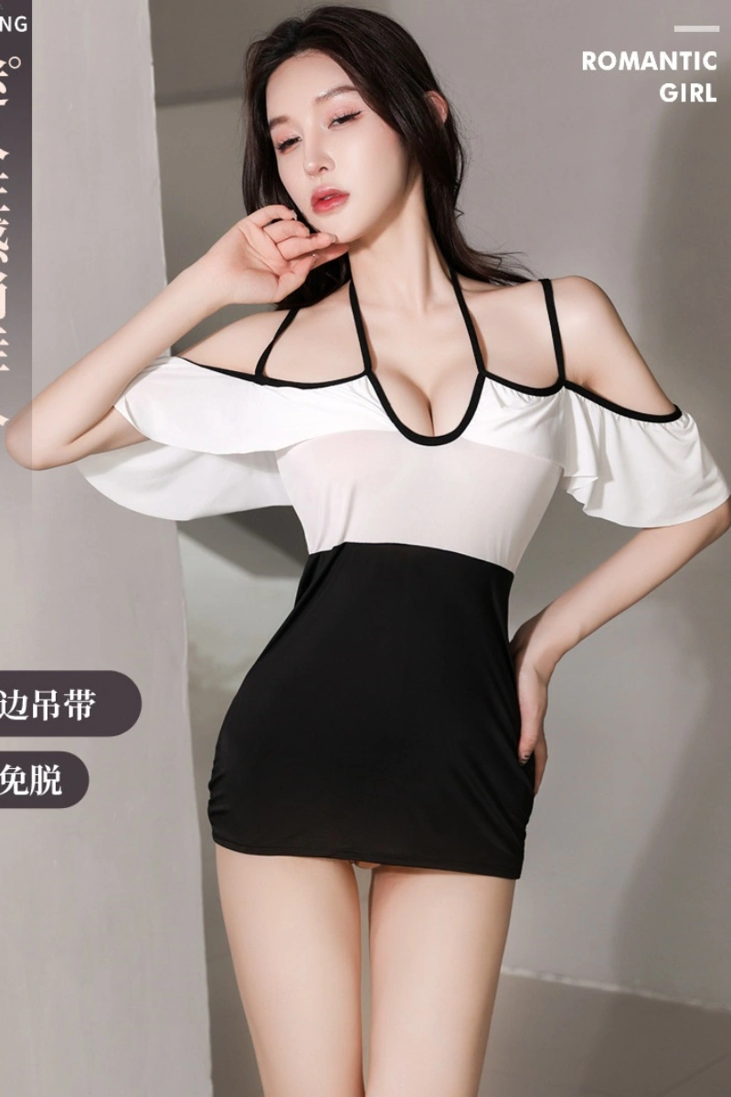 Model wearing a wholesale sexy secretary outfit in black and white with open shoulder straps and halter neckline.