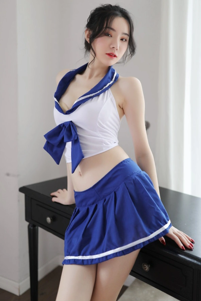 Front view of wholesale student lingerie featuring a sailor collar crop top with bow tie and matching mini skirt.