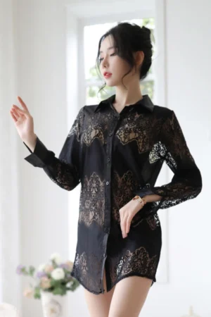 Model posing in wholesale lace secretary outfit made of black sheer lace with long sleeves