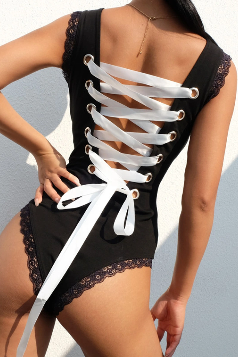 Alt text: Wholesale leopard lingerie set for women in black with white lace-up ribbon