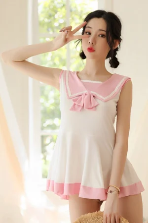 Wholesale cute student uniform in white with sleeveless cut and pink collar bow, suitable for bulk orders.
