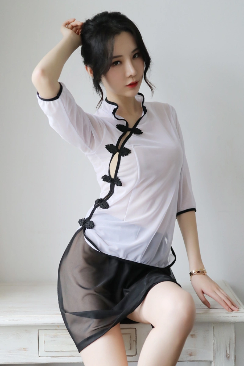 Model posing in wholesale traditional cheongsam lingerie featuring white sheer fabric and black trim accents