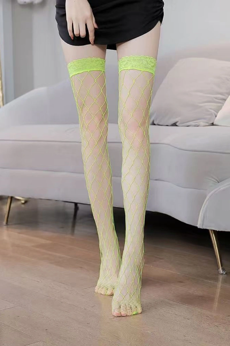 Model in nude fishnet wholesale vintage silk stockings finished with neon yellow lace top, barefoot style.