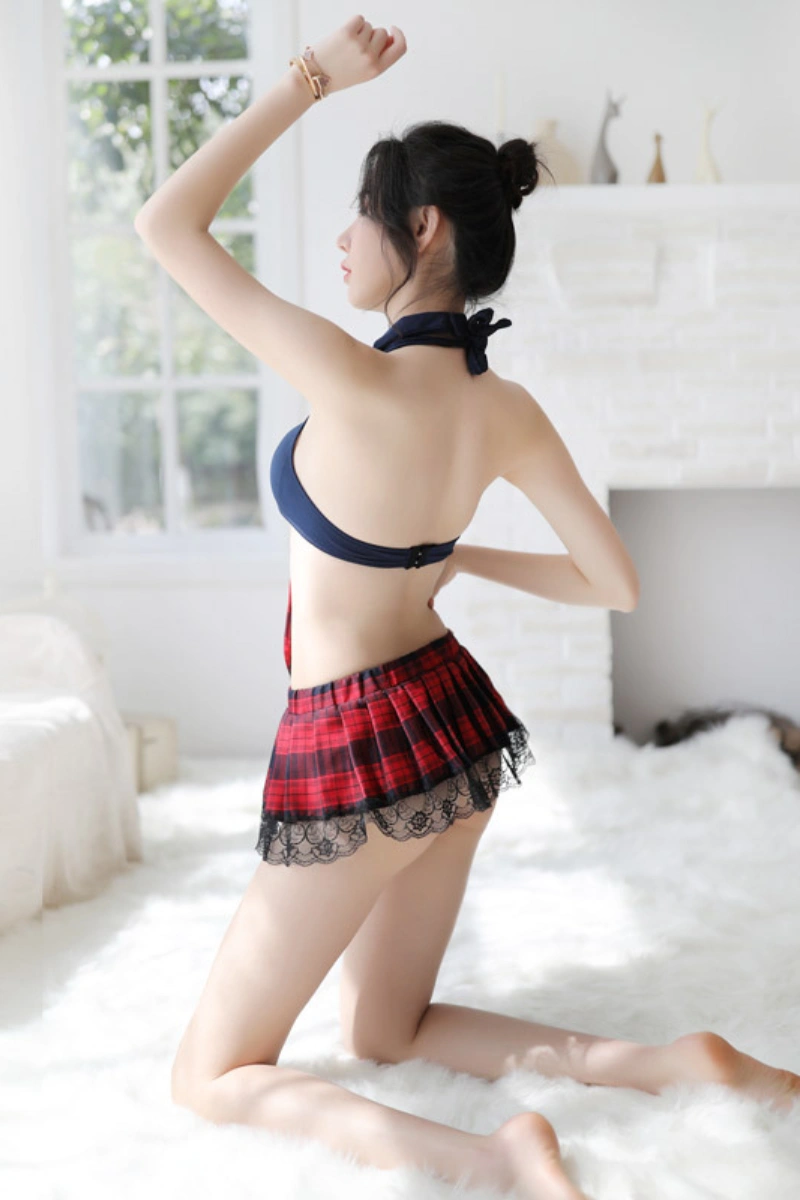 Back view of b2b lace student costume featuring red plaid pleated skirt with lace hem and navy halter top