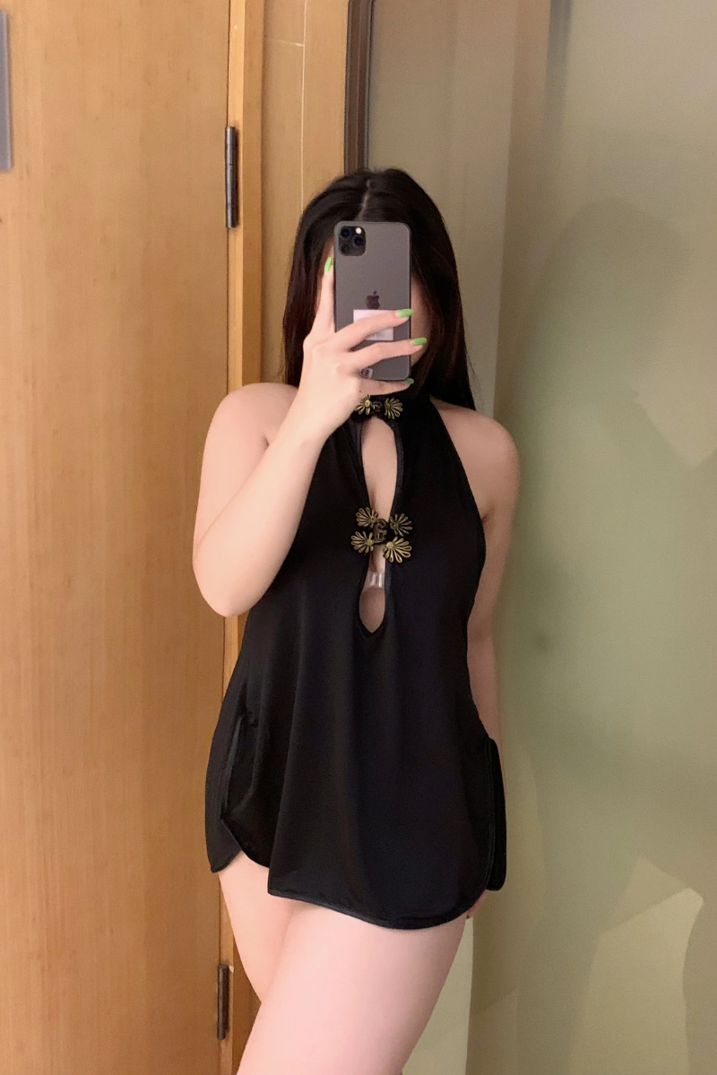 Woman in black cheongsam lingerie for women, halter neck design, floral golden button closure, sexy and elegant look.