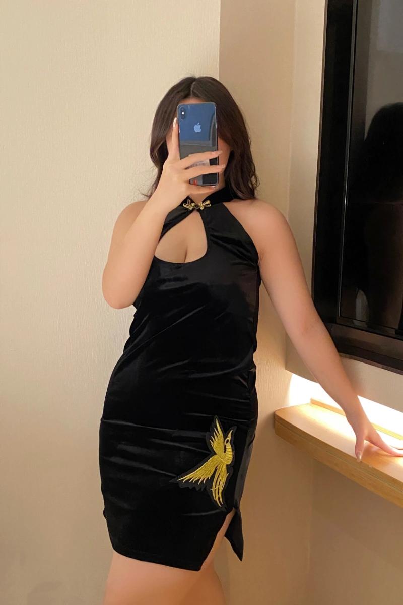 Model wearing a black cheongsam lingerie dress with golden embroidery and sexy cut-out neckline.