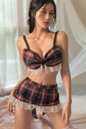 Model wearing a plaid b2b JK cosplay costume with lace trim and matching skirt in a soft indoor setting.