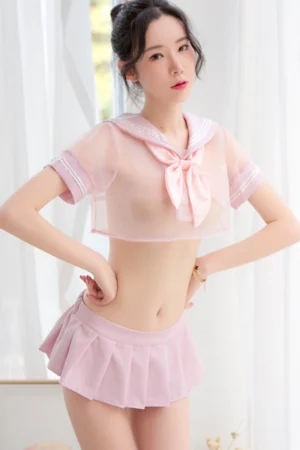 Sexy model dressed in a light pink JK sheer lingerie set with sailor collar and pleated skirt