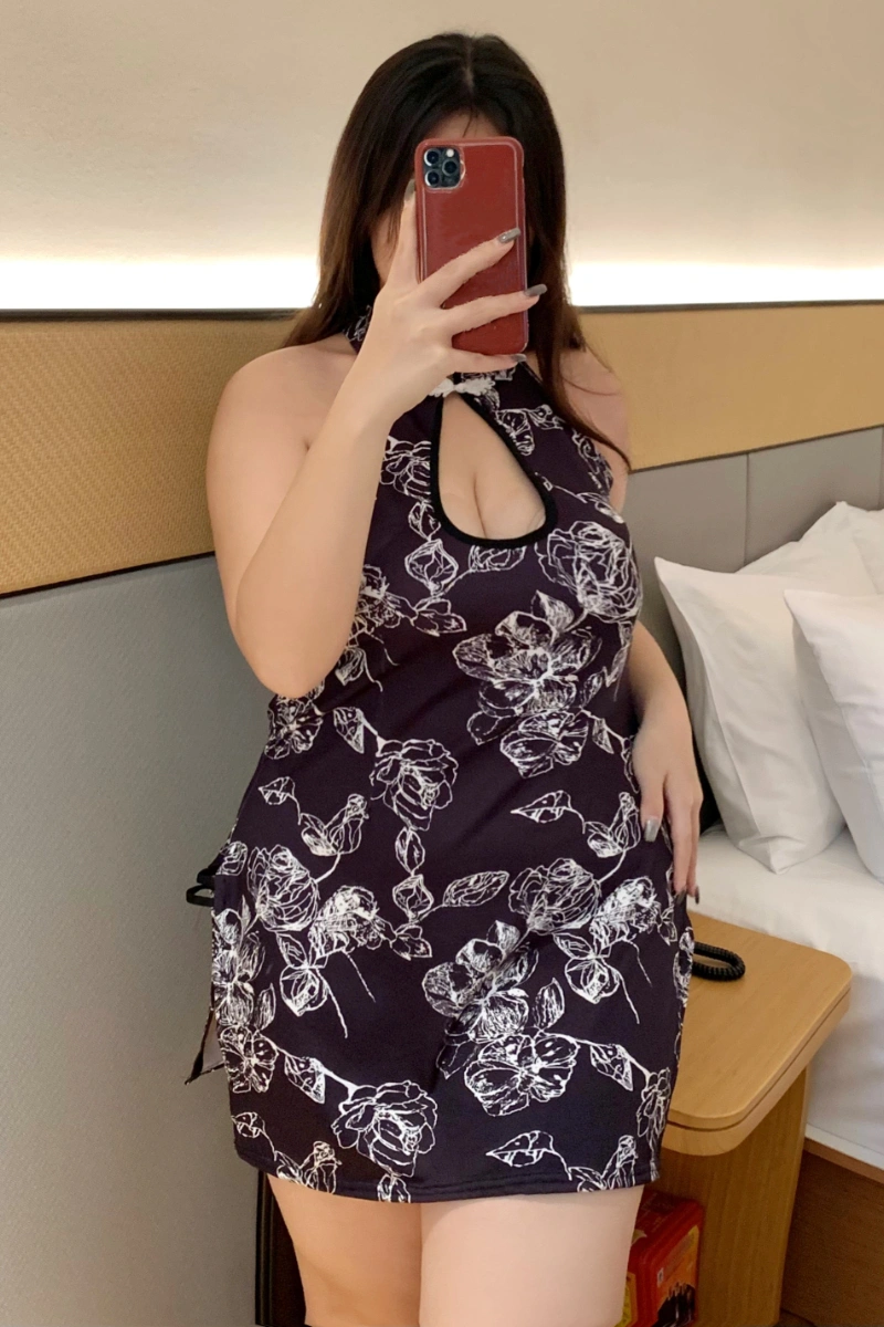 Woman showcasing floral cheongsam lingerie in black with white floral patterns