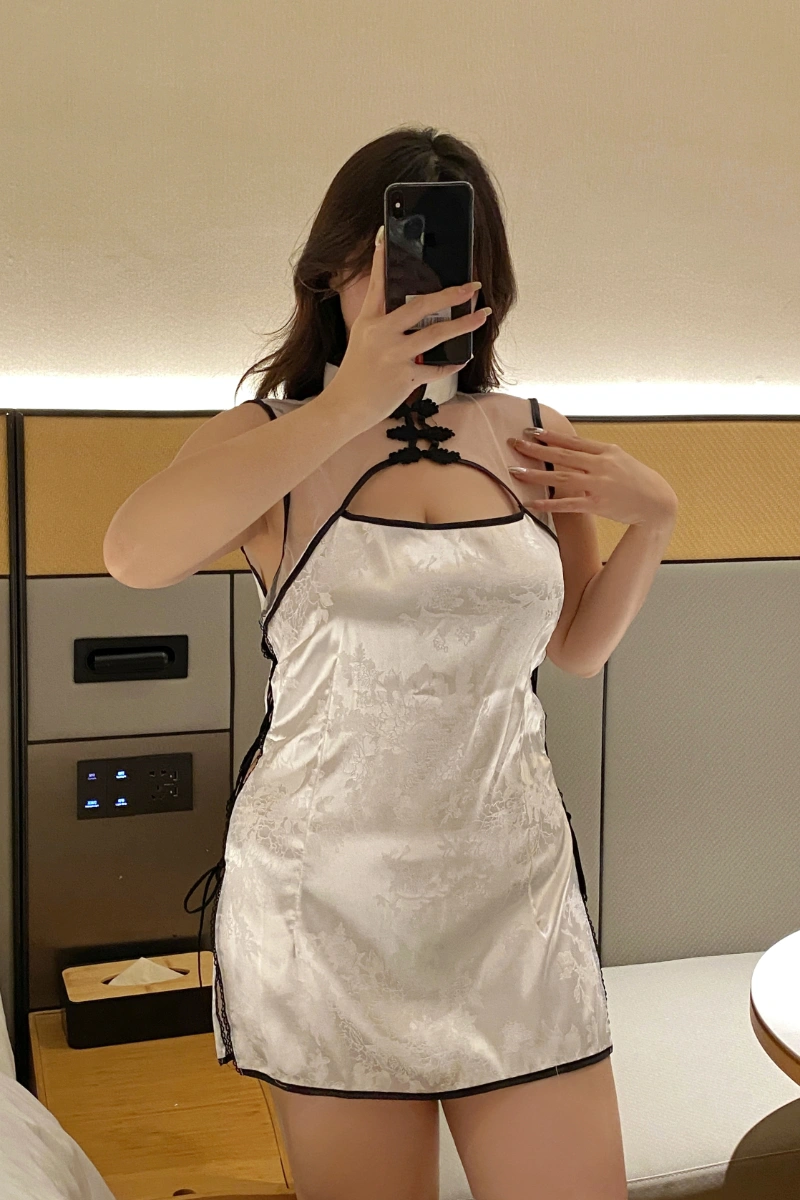 Sexy qipao lingerie in elegant white satin with black trim, featuring side ties and sheer neckline.