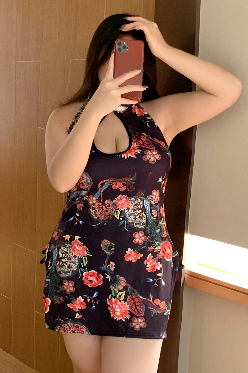 Woman posing in floral cheongsam lingerie with vibrant multicolor floral prints