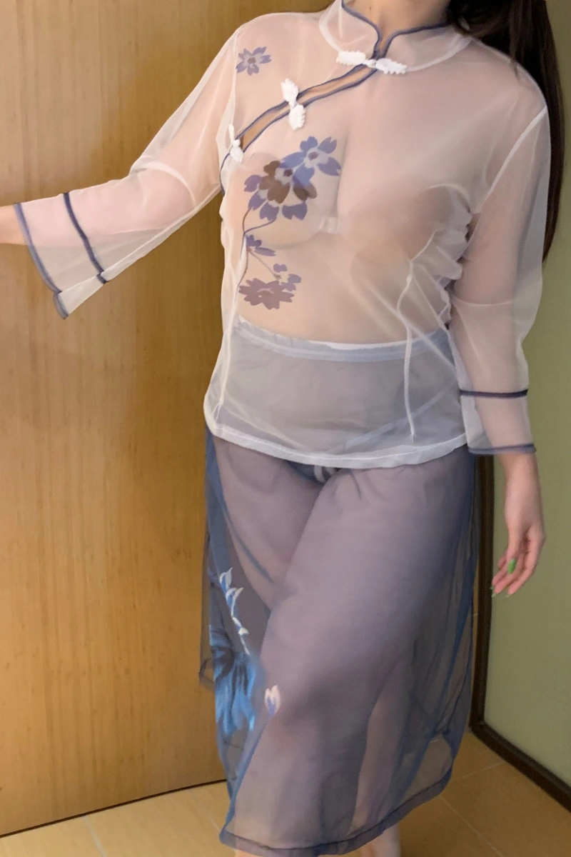 Woman wearing white cheongsam lingerie featuring transparent mesh and blue trim details.