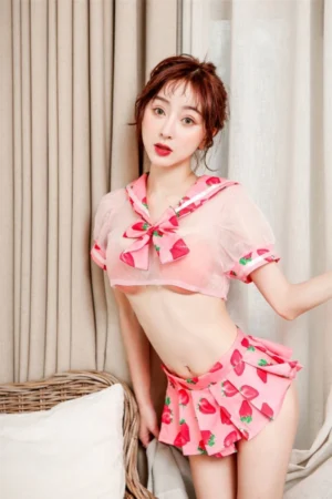 Front view of wholesale sexy student costume with sheer pink sailor crop top and strawberry print mini skirt.