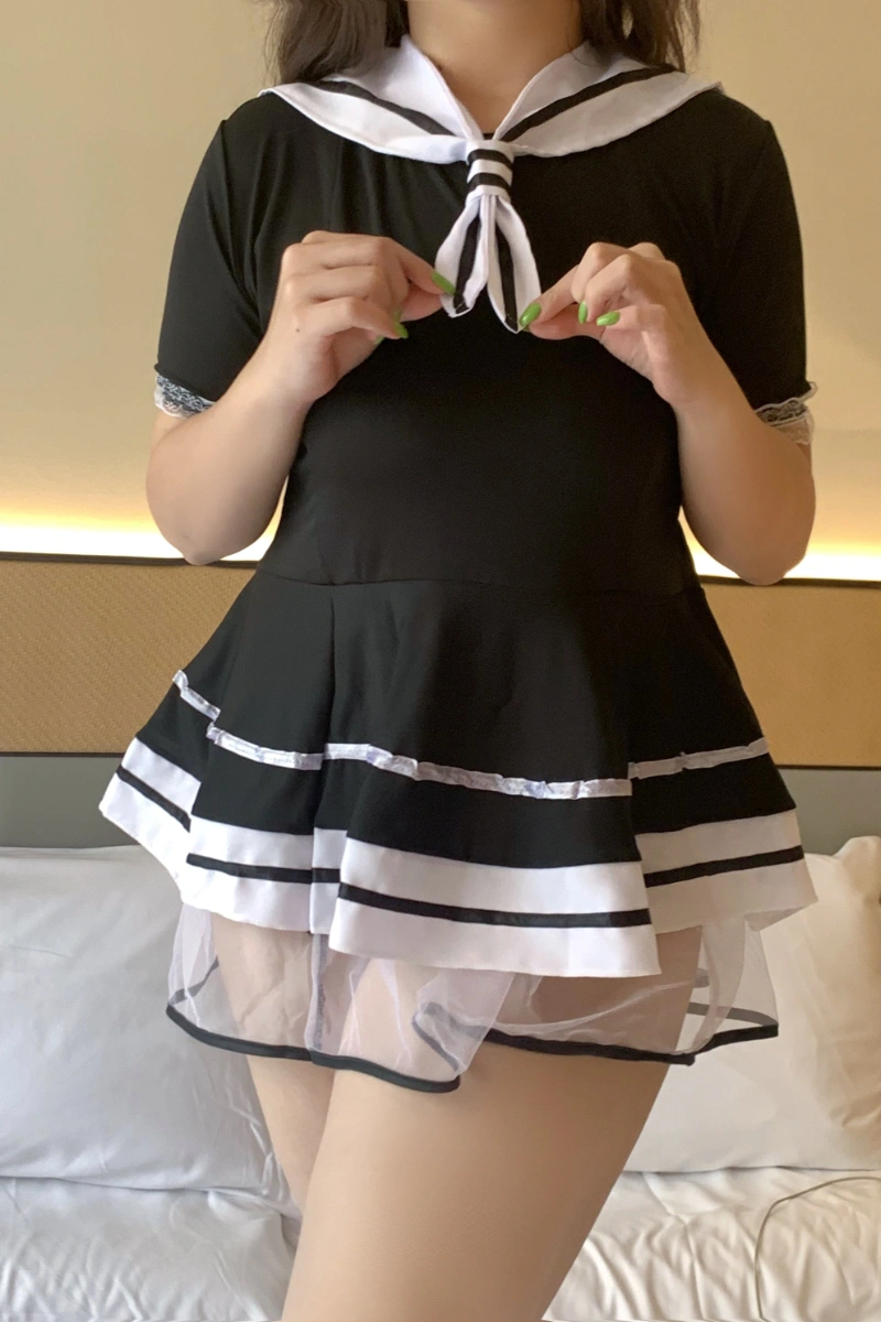 Front view of a student costume with sailor collar, ribbon tie, and black short-sleeve design.